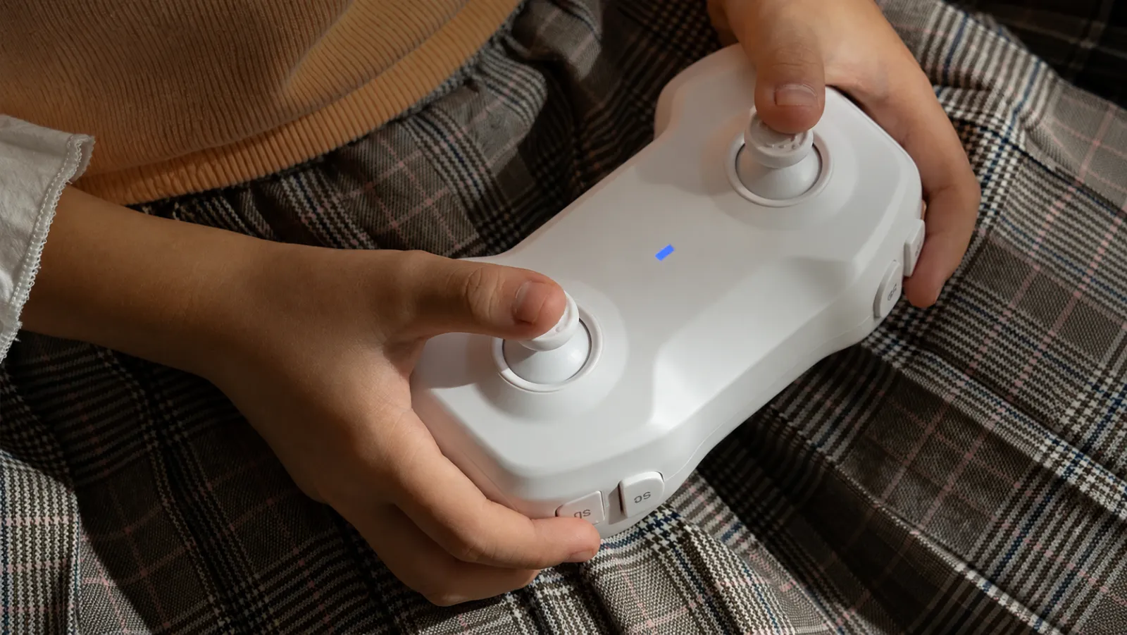 Close-up of hands on a drone racing controller